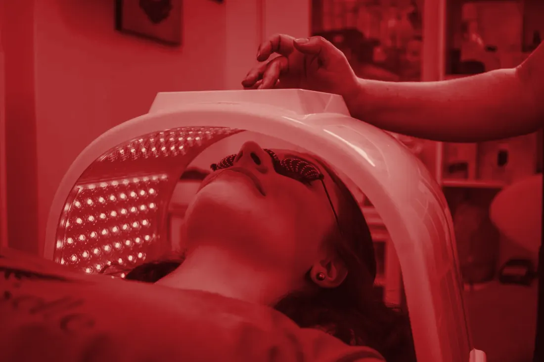 LED face mask red light therapy session in a calm spa setting
